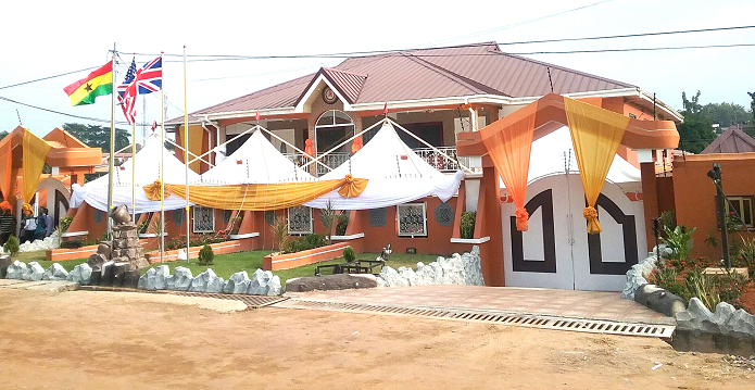  The Deputy Ashanti Regional Minister speaking at the inaugural ceremony of the hotel (INSET). Front view of the hotel